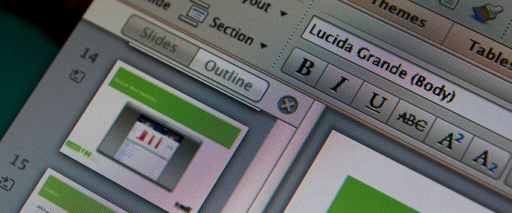 Close-up of a computer screen displaying PowerPoint presentation software with a slide outline on the left showing thumbnails. The text formatting toolbar on the right offers options for font style, size, and text alignment, with "Lucida Grande (Body)" selected.