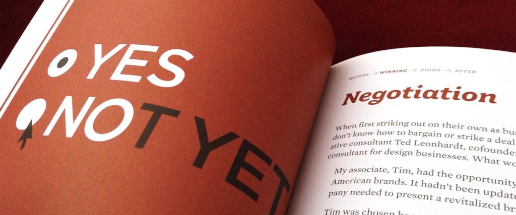 An open book displaying pages with text. The left page features the large words "YES" and "NOT YET" with stylized graphics. The right page is titled "Negotiation" and contains partially readable paragraphs, reminiscent of a pitch deck layout.