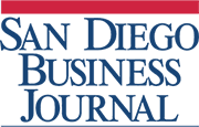 Logo of San Diego Business Journal, featuring the name in bold, blue uppercase letters. The text is aligned to the left, with a red horizontal stripe above it – a clean design perfect for any presentation slide.
