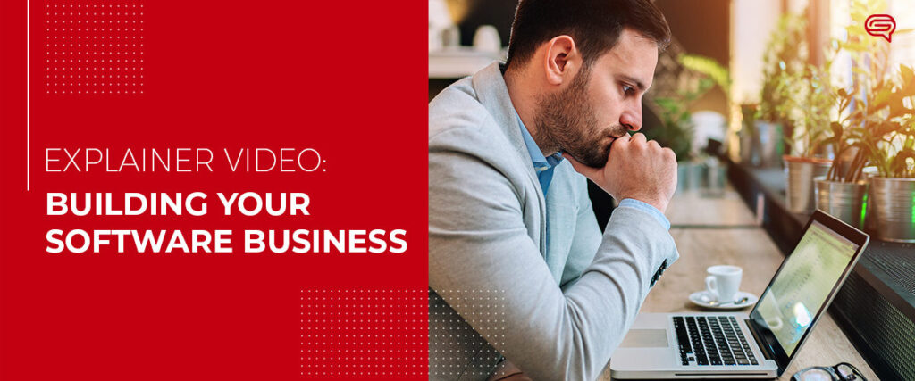 A man wearing a grey blazer is sitting at a desk, looking thoughtfully at his laptop. Beside him is a cup of coffee. The text reads "Explainer Video: Building Your Software Business" on a red background, suggesting valuable insights for your next presentation.