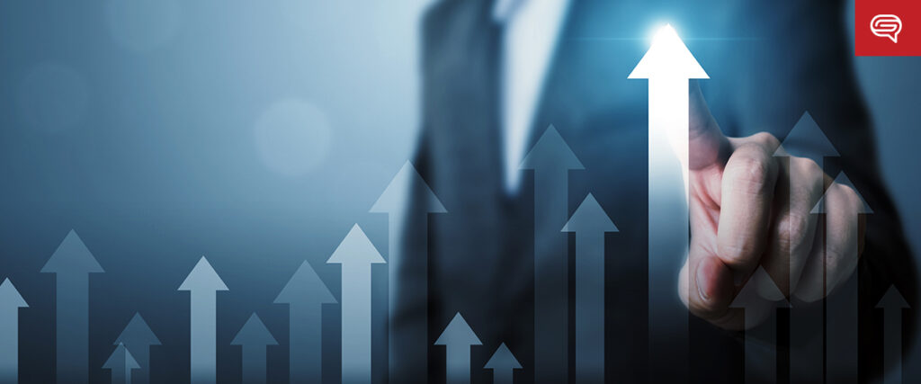 A person in a suit points upward on a transparent arrow graphic, symbolizing growth or progress. The background features several other arrows pointing upwards, creating a feeling of advancement and success—ideal for use in a PowerPoint presentation or pitch deck.