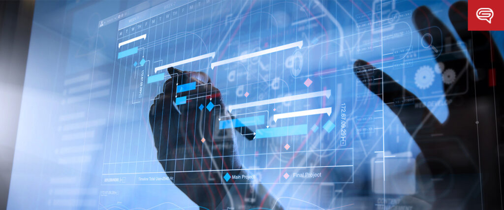 A person interacts with a transparent digital display showing a Gantt chart with various project timelines and tasks. The futuristic interface includes presentation icons and data visualizations. The background is blurred, emphasizing the display and the hand.