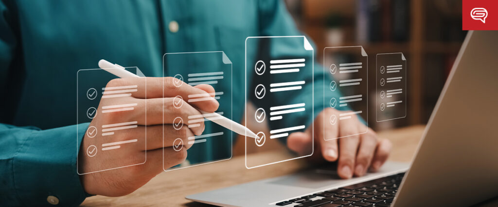 A person uses a stylus to interact with floating digital checklists on a screen in front of a laptop. The scene suggests a task management or productivity application, similar to organizing slides for a PowerPoint presentation, with a focus on organization and technology.