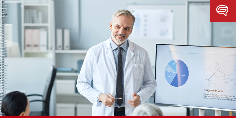 Doctor Presenting Biotech Data with Charts in Modern Office