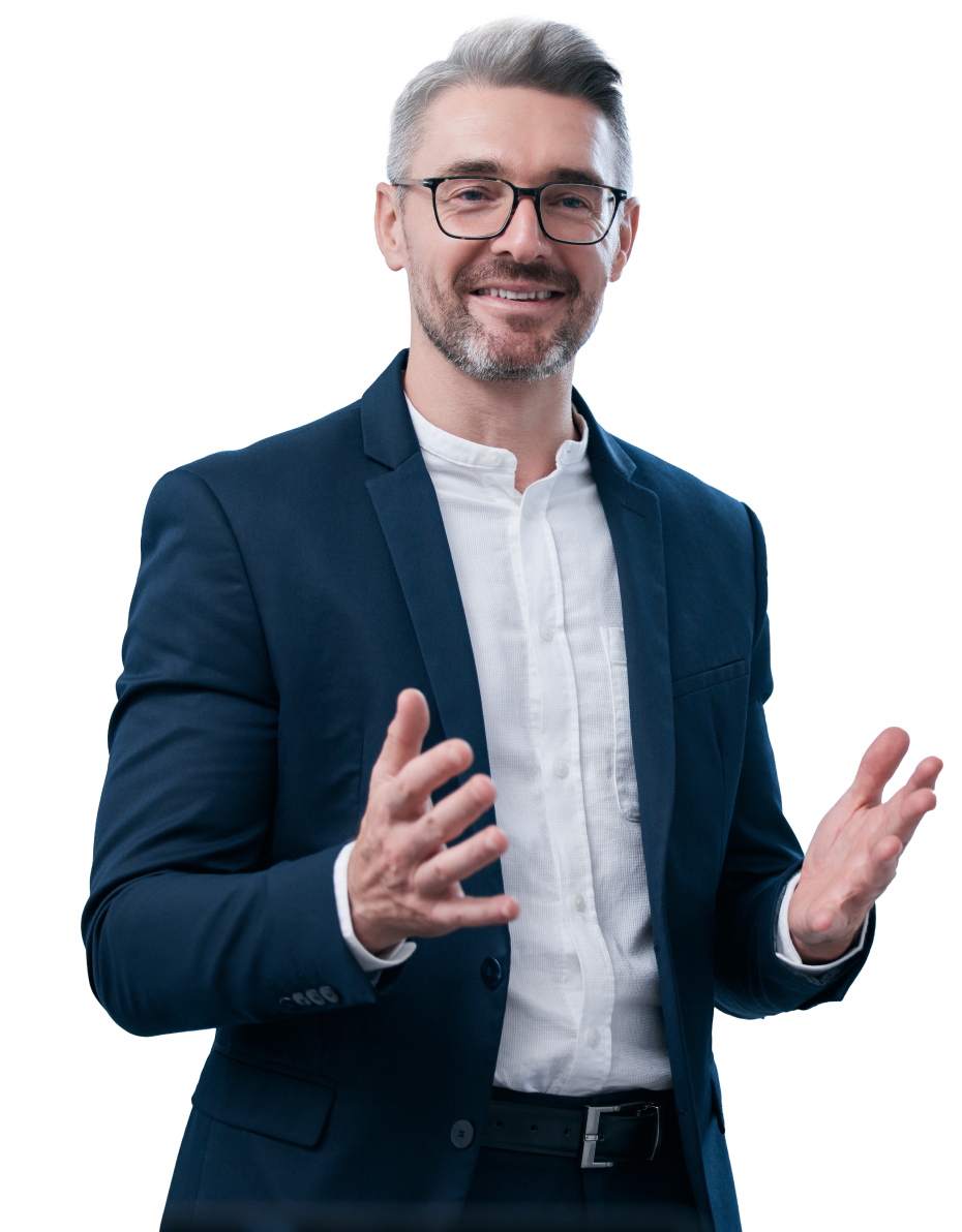 A man wearing glasses and a navy blue suit with a white shirt stands smiling, his hands raised in a gesturing manner. With short gray hair and a beard, he appears ready for visual training presentations. The background is transparent.